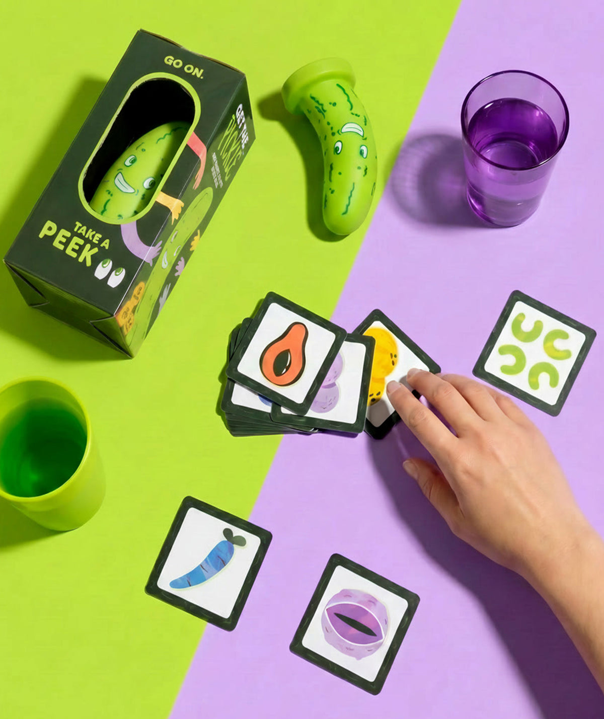 Get the pickle game and cards on a green and purple table